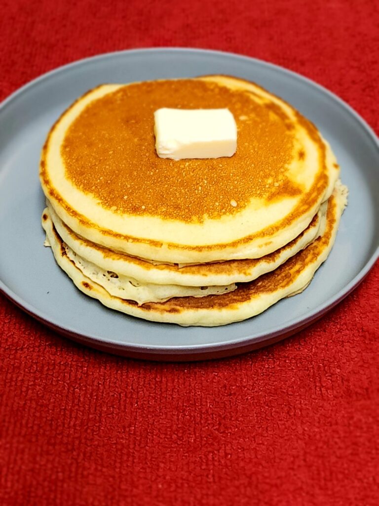 Copycat McDonalds pancakes with butter on a plate.